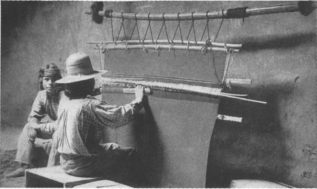 Copyright by H. S. Poley

A Hopi Indian weaving a rug on a hand loom in a deserted cave