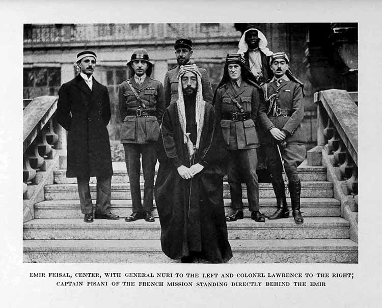 Photograph: EMIR FEISAL, CENTER, WITH GENERAL NURI TO THE LEFT
    AND COLONEL LAWRENCE TO THE RIGHT, CAPTAIN PISANI OF THE FRENCH
    MISSION STANDING DIRECTLY BEHIND THE EMIR